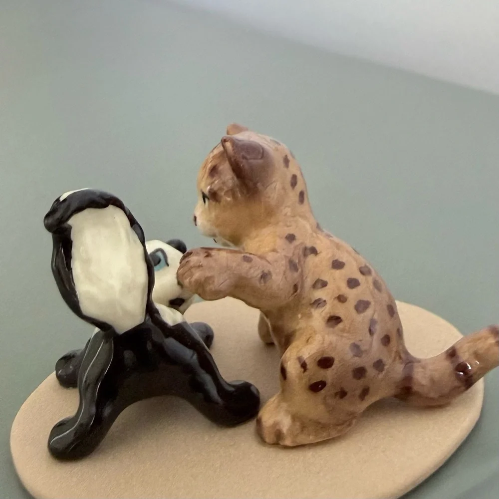Vintage retired Hagen Renaker bobcat and skunk babies on base